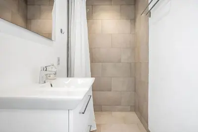 a white bathroom with a sink and a shower at 1341-Thisted-Mose-Bolle-Vej-5 in Thisted