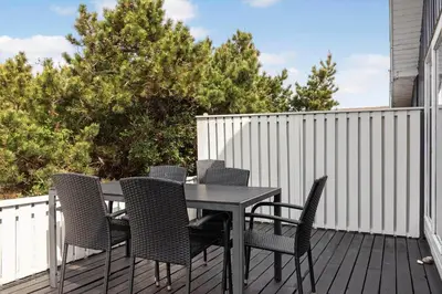 a black table and chairs on a deck at 1336-Thisted-Nordsovej-50 in Thisted