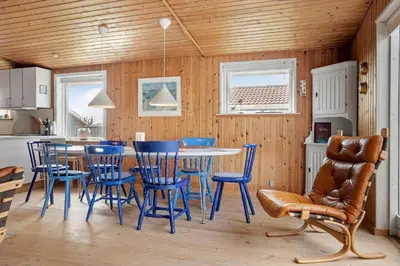 a kitchen with blue chairs and a table in a room at 1336-Thisted-Nordsovej-50 in Thisted