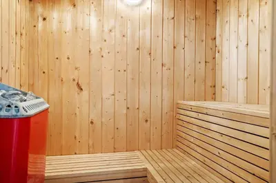 a sauna with a trash can and a wooden wall at 1340-Thisted-Nordsovej-104 in Thisted