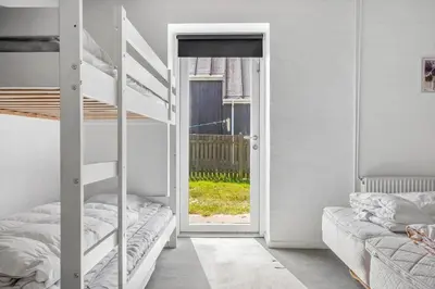 a bedroom with two bunk beds and a door to a yard at 1340-Thisted-Nordsovej-104 in Thisted