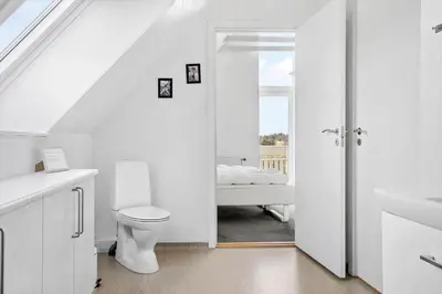 a white bathroom with a toilet and a sink at 1340-Thisted-Nordsovej-104 in Thisted