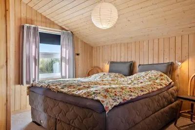 a bedroom with a bed in a room with a window at 1062-Thisted-Mombak-45 in Torsted