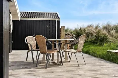 a table and chairs sitting on a wooden deck at 1062-Thisted-Mombak-45 in Torsted