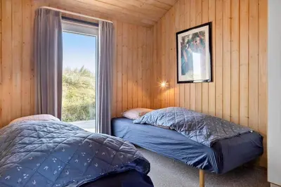 two beds in a room with a window at 1062-Thisted-Mombak-45 in Torsted