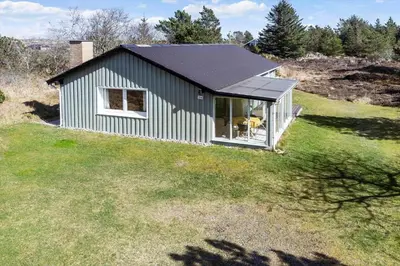 a small house with a solar roof on a field at 246-Thisted-Pighvarvej-16 in Thisted