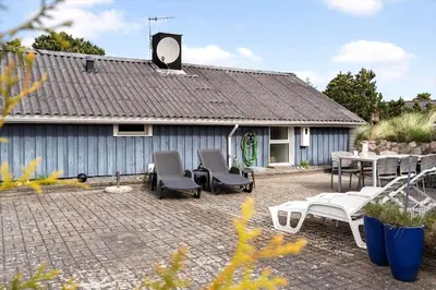 a patio with chairs and tables and a building at 1342-Thisted-Mose-Bolle-Vej-8 in Thisted