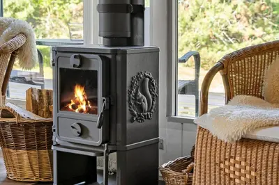 a stove with a fire in a living room at 1344-Vestervig-Hedevej-43 in Vestervig