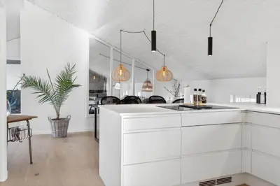a kitchen with white cabinets and pendant lights at 1064-Thisted-Klitstien-25 in Torsted