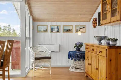 a kitchen with a sink and a table and chairs at 1326-Thisted-Blabaervej-6 in Thisted