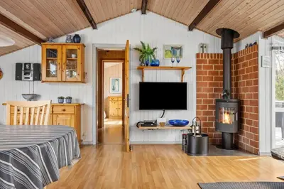 a living room with a television and a fireplace at 1326-Thisted-Blabaervej-6 in Thisted
