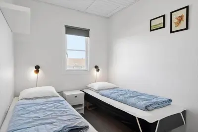 a bedroom with two beds and a window at 1346-Vestervig-Havnevej-1-lejl-15 in Vestervig
