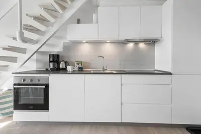 a white kitchen with white cabinets and a sink at 1346-Vestervig-Havnevej-1-lejl-15 in Vestervig