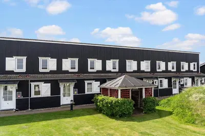 a black building with white windows and a yard at 1346-Vestervig-Havnevej-1-lejl-15 in Vestervig