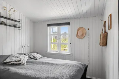 a white bedroom with a bed and a window at 1350-Thisted-Blabaervej-22 in Thisted