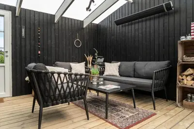 a living room with a couch and a table at 1350-Thisted-Blabaervej-22 in Thisted