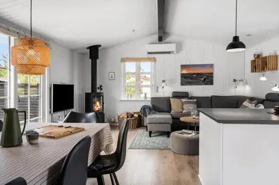 a kitchen and living room with a table and chairs at 1350-Thisted-Blabaervej-22 in Thisted