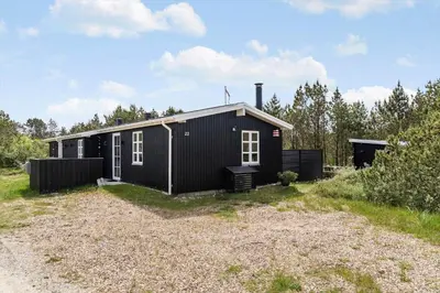 a black house in the middle of a yard at 1350-Thisted-Blabaervej-22 in Thisted