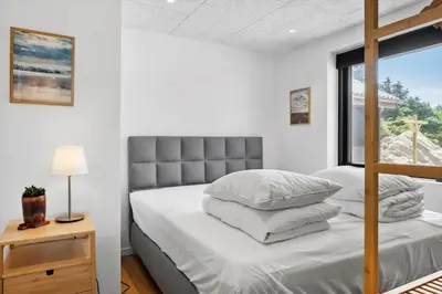 a bedroom with a bed with white walls and a window at 1068-Thisted-Klovborgsti-5-A in Torsted