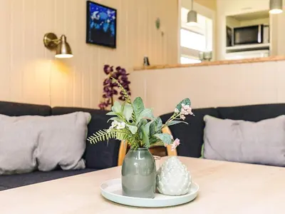 a vase filled with flowers on a table at Holiday home for family in Denmark in Løgsted