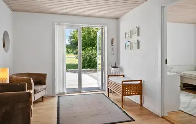 a living room with a door to a patio at 4 Bedroom Nice Home In Bedsted Thy in Bedsted Thy