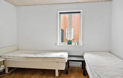 two beds in a room with a window at 4 Bedroom Nice Home In Bedsted Thy in Bedsted Thy