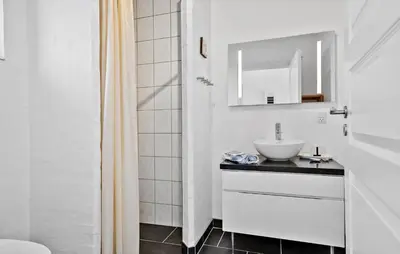a white bathroom with a sink and a toilet at 4 Bedroom Nice Home In Bedsted Thy in Bedsted Thy