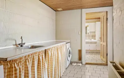 a kitchen with a sink and a washing machine at Lovely Home In Thyholm With Wifi in Thyholm
