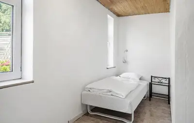 a bed in a white room with a window at Lovely Home In Thyholm With Wifi in Thyholm