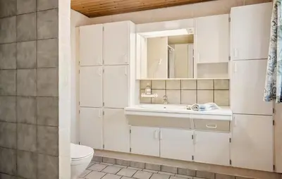 a white bathroom with a sink and a toilet at Lovely Home In Thyholm With Wifi in Thyholm