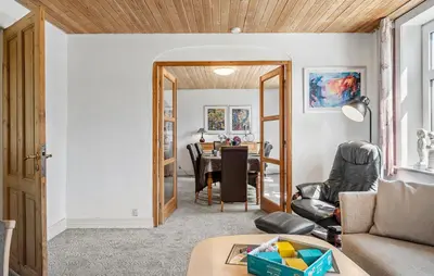 a living room with a couch and a table at Lovely Home In Thyholm With Wifi in Thyholm