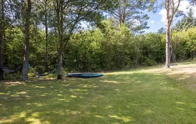 a hammock in a field next to some trees at 4 Bedroom Cozy Home In Fur in Fur