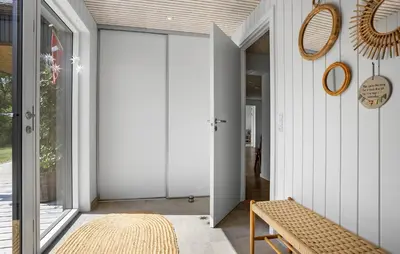 a hallway with a sliding door and a bench at 4 Bedroom Cozy Home In Fur in Fur