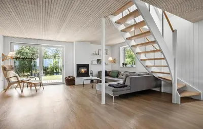 a living room with a staircase and a couch at 4 Bedroom Cozy Home In Fur in Fur