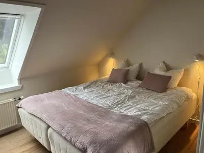 a bedroom with a large bed with two pillows at Cozy property in the countryside in beautiful nature in Vinderup