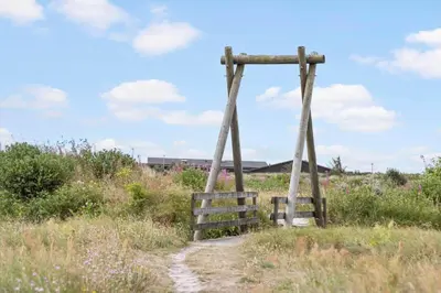 an old wooden bridge in a field of grass at 1351-Thisted-Mose-Bollevej-13 in Thisted