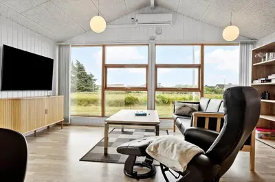 a living room with a couch and a tv at 1351-Thisted-Mose-Bollevej-13 in Thisted