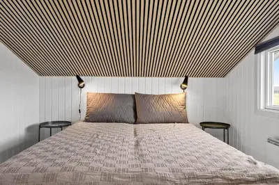 a bedroom with a bed with a striped ceiling at 1351-Thisted-Mose-Bollevej-13 in Thisted