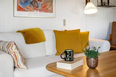 a living room with a white couch and a coffee table at 1353-Snedsted-Ebenezervej-24 in Snedsted