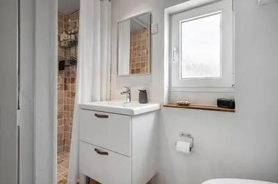 a white bathroom with a sink and a window at 1353-Snedsted-Ebenezervej-24 in Snedsted