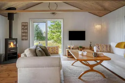 a living room with a couch and a table at 1353-Snedsted-Ebenezervej-24 in Snedsted