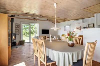 a kitchen and dining room with a table and chairs at 1353-Snedsted-Ebenezervej-24 in Snedsted