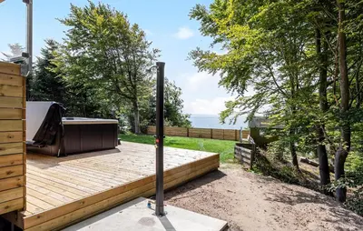 a wooden deck with a hot tub on it at Awesome Home In Spøttrup With Wifi in Spottrup