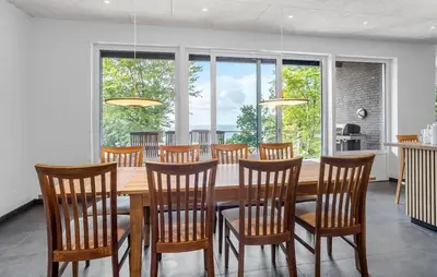 a dining room with a wooden table and chairs at Awesome Home In Spøttrup With Wifi in Spottrup