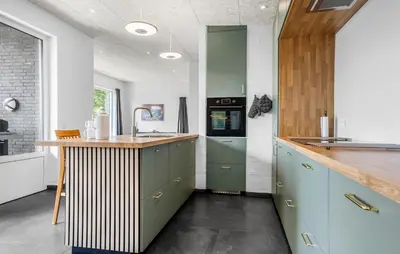 a kitchen with green cabinets and a counter with a sink at Awesome Home In Spøttrup With Wifi in Spottrup