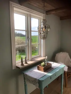 a table in a room with a window at Lykkeholms Bella Vista in Spottrup