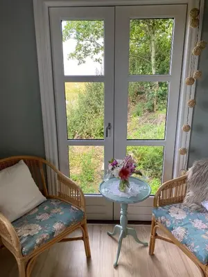 a room with two chairs and a table and a window at Lykkeholms Bella Vista in Spottrup