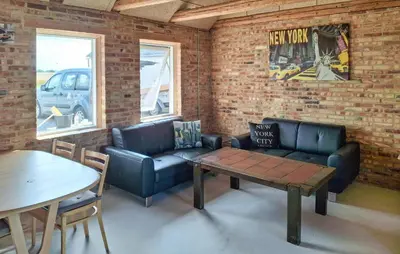 a living room with a couch and a table at 3 Bedroom Amazing Home In Erslev in Erslev
