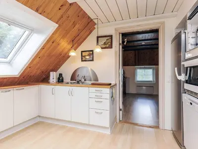 a kitchen with white cabinets and a wooden ceiling at 6 person holiday home in Thisted in Thisted