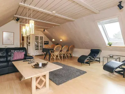 a living room with a black couch and chairs at 6 person holiday home in Thisted in Thisted